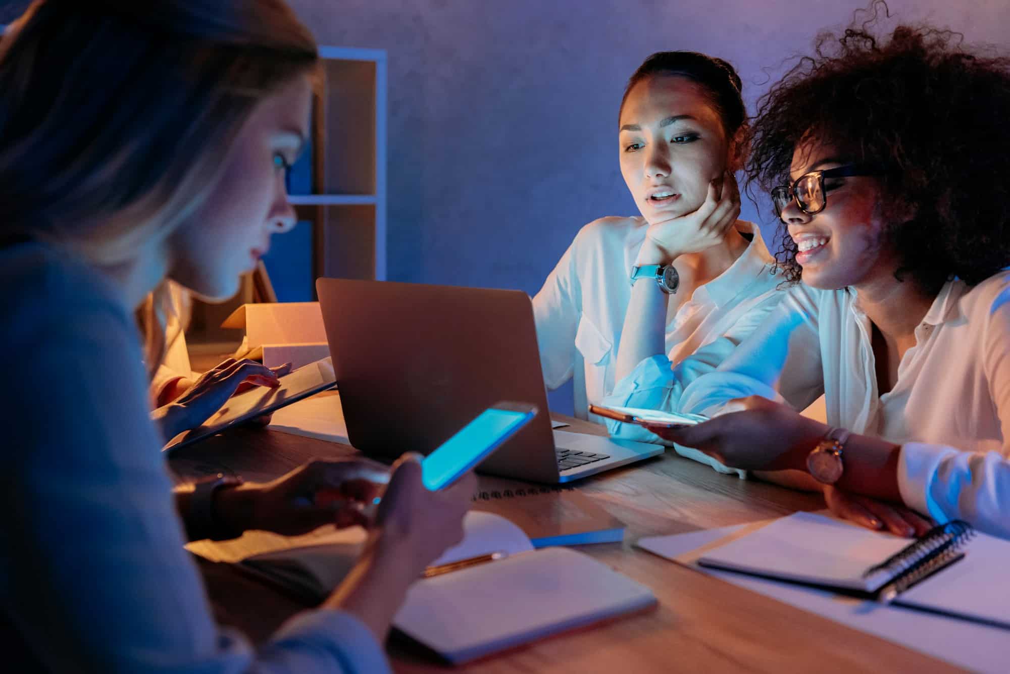 young multiethnic businesswomen working with digital devices at home office